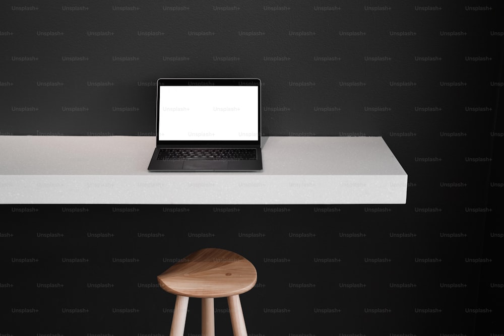 a laptop computer sitting on top of a white counter