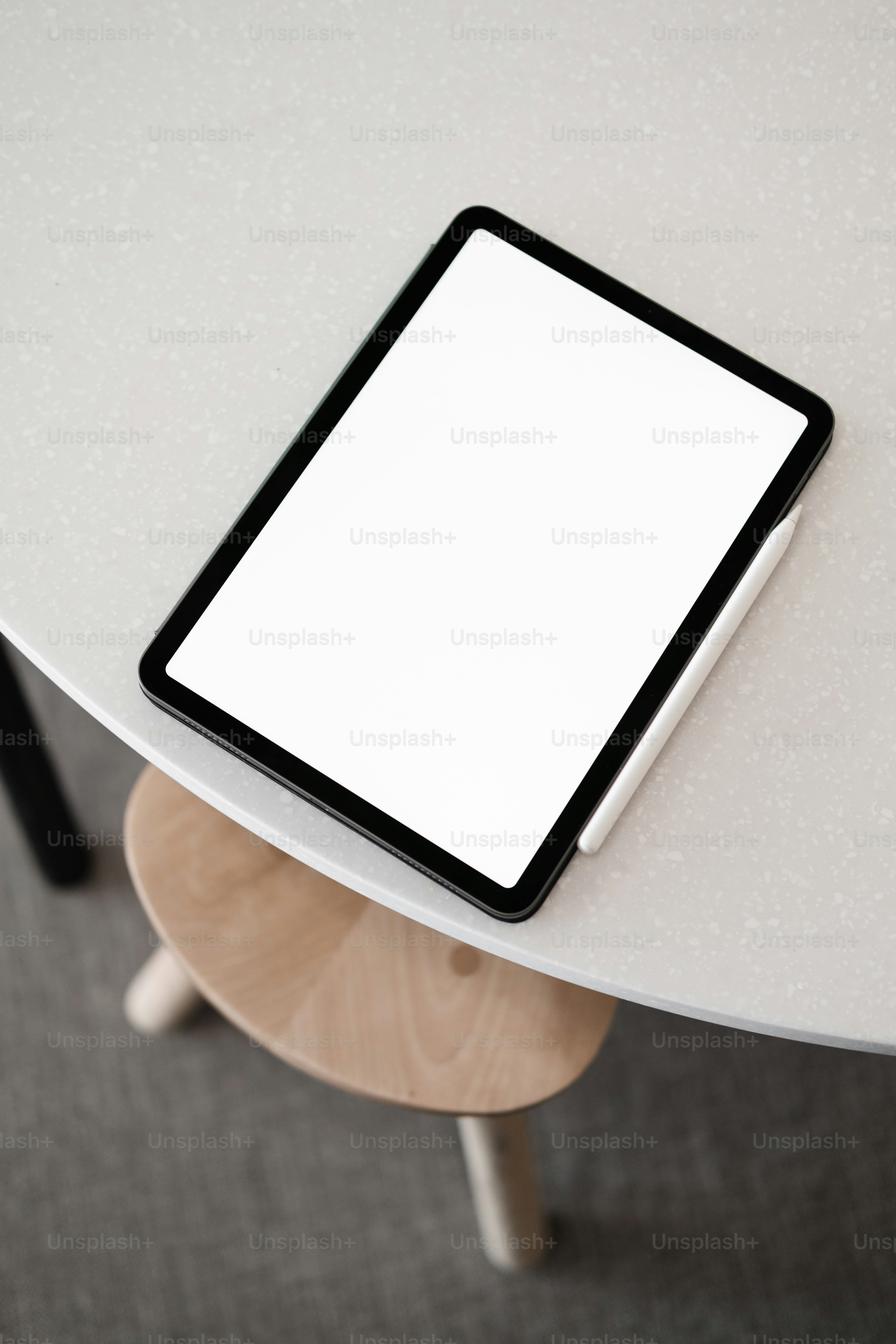 a tablet computer sitting on top of a white table