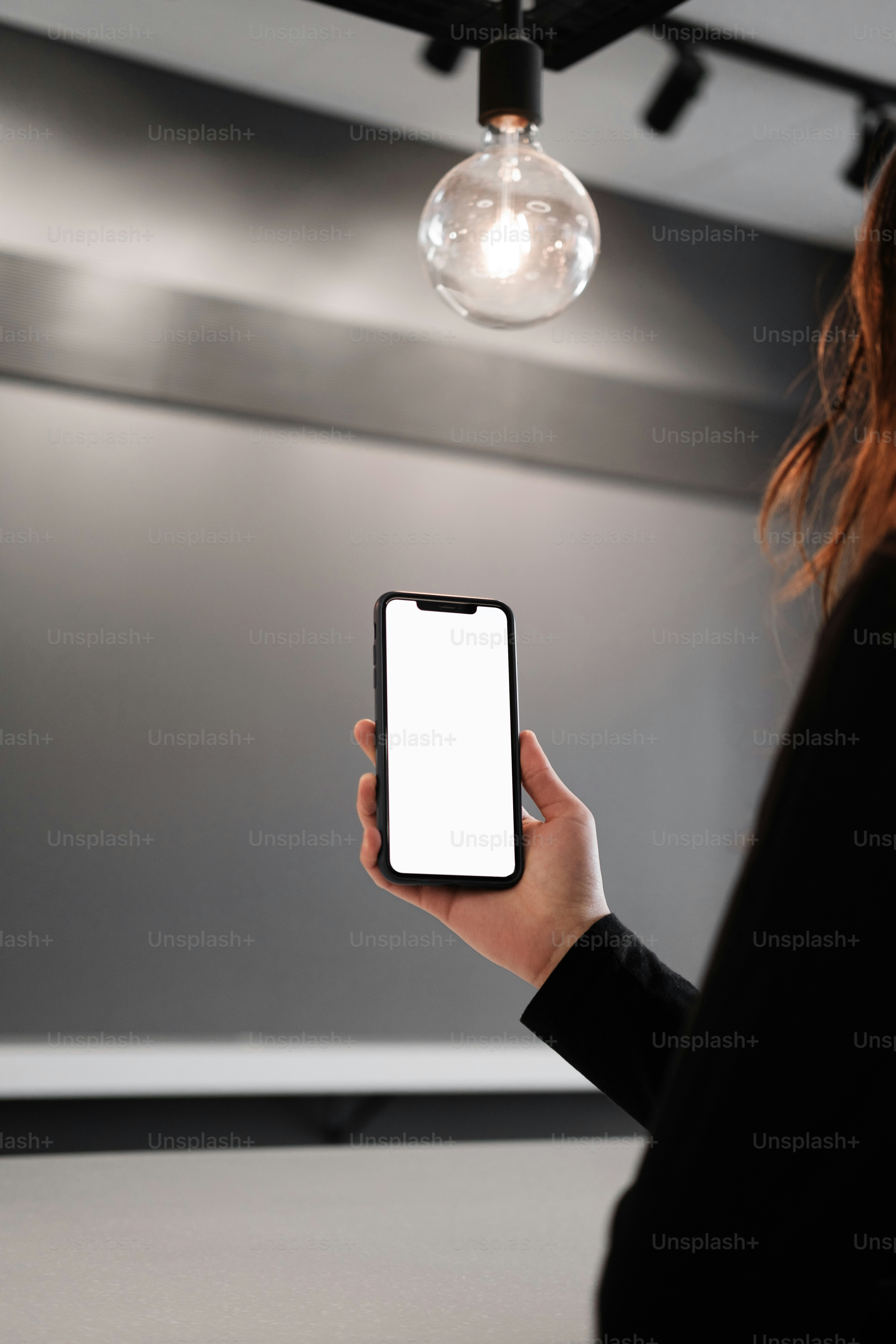 a person holding a cell phone in their hand