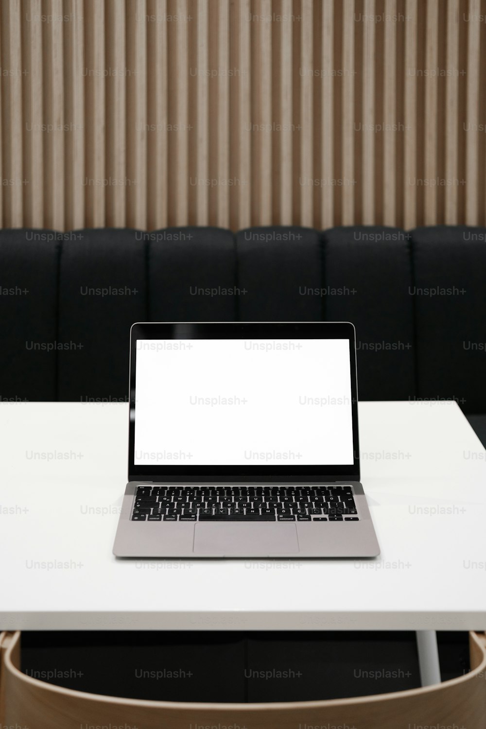 a laptop computer sitting on top of a white table