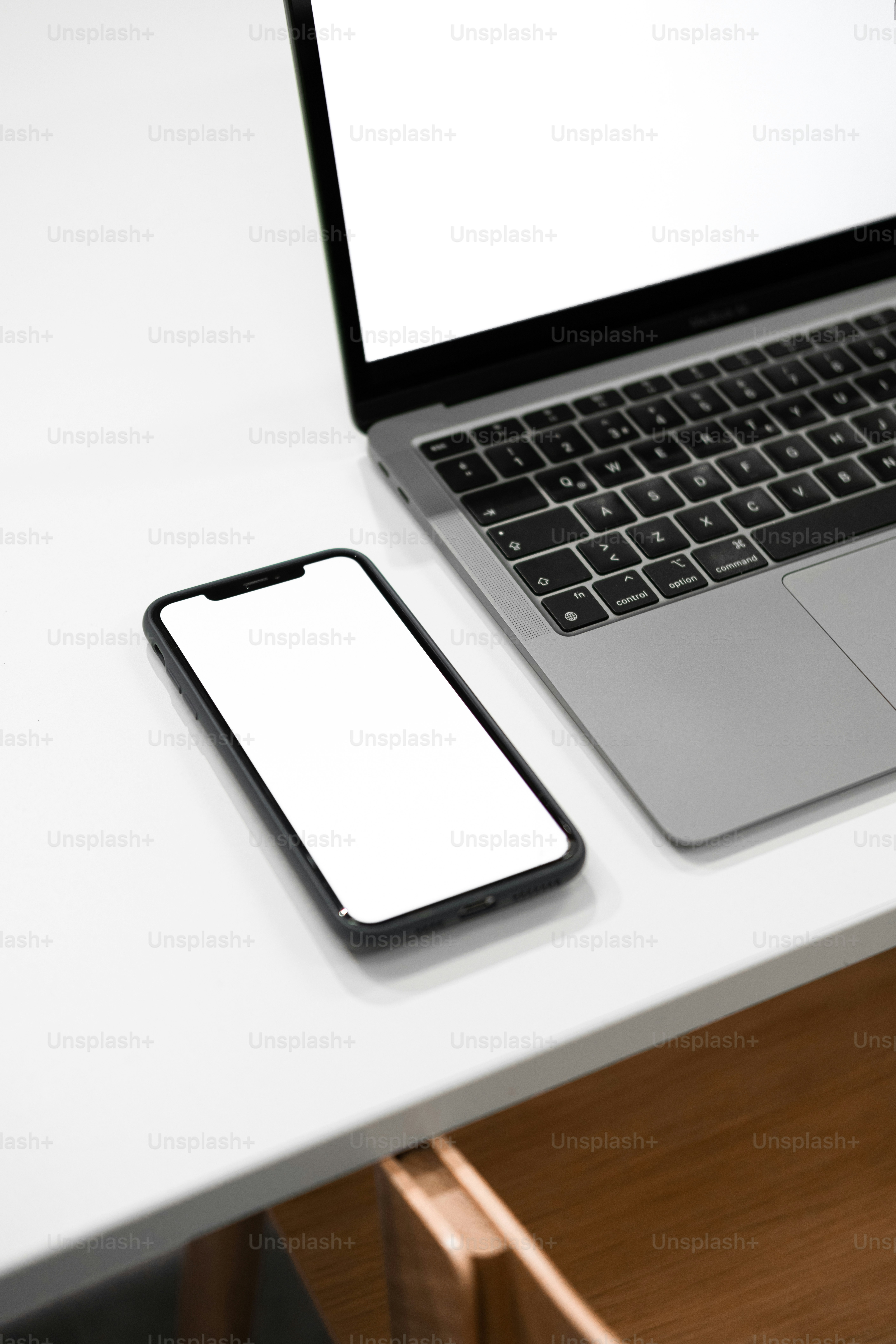 a laptop computer sitting on top of a white desk