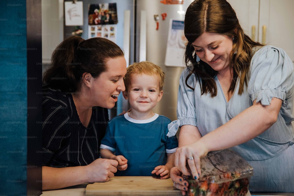 a woman and two children in a kitchen