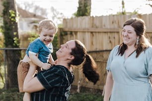 a woman holding a baby up to her face