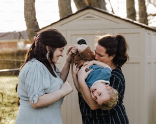 a woman holding a baby in her arms