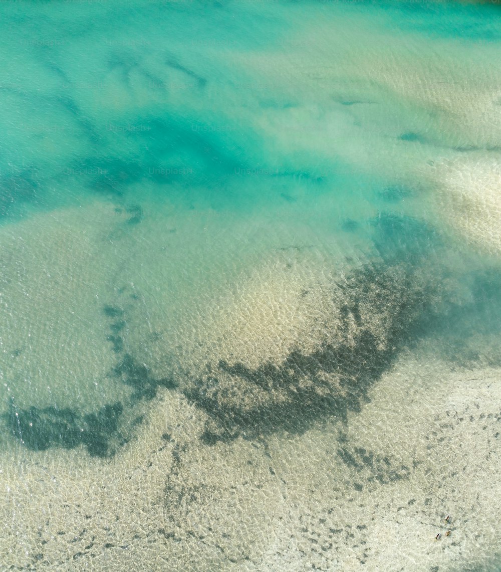 an aerial view of the water and sand at the beach