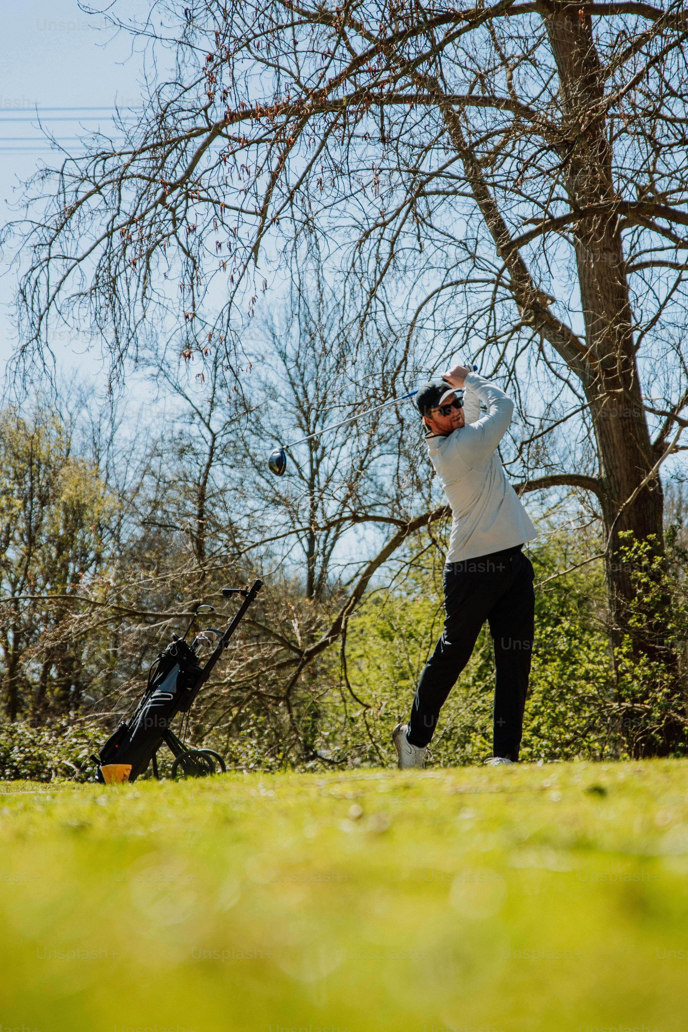 a man swinging a golf club at a ball