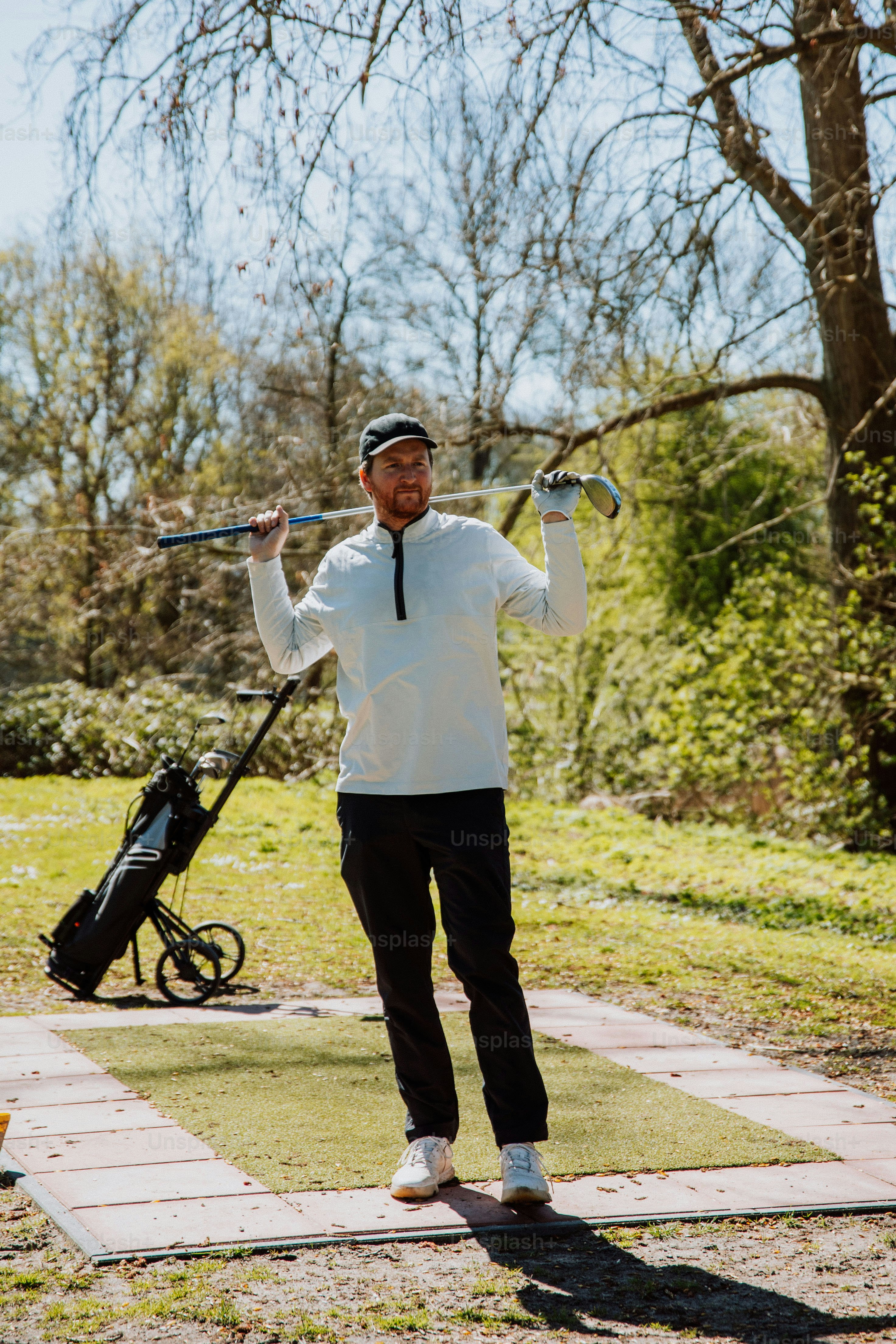 a man holding a stick in a park