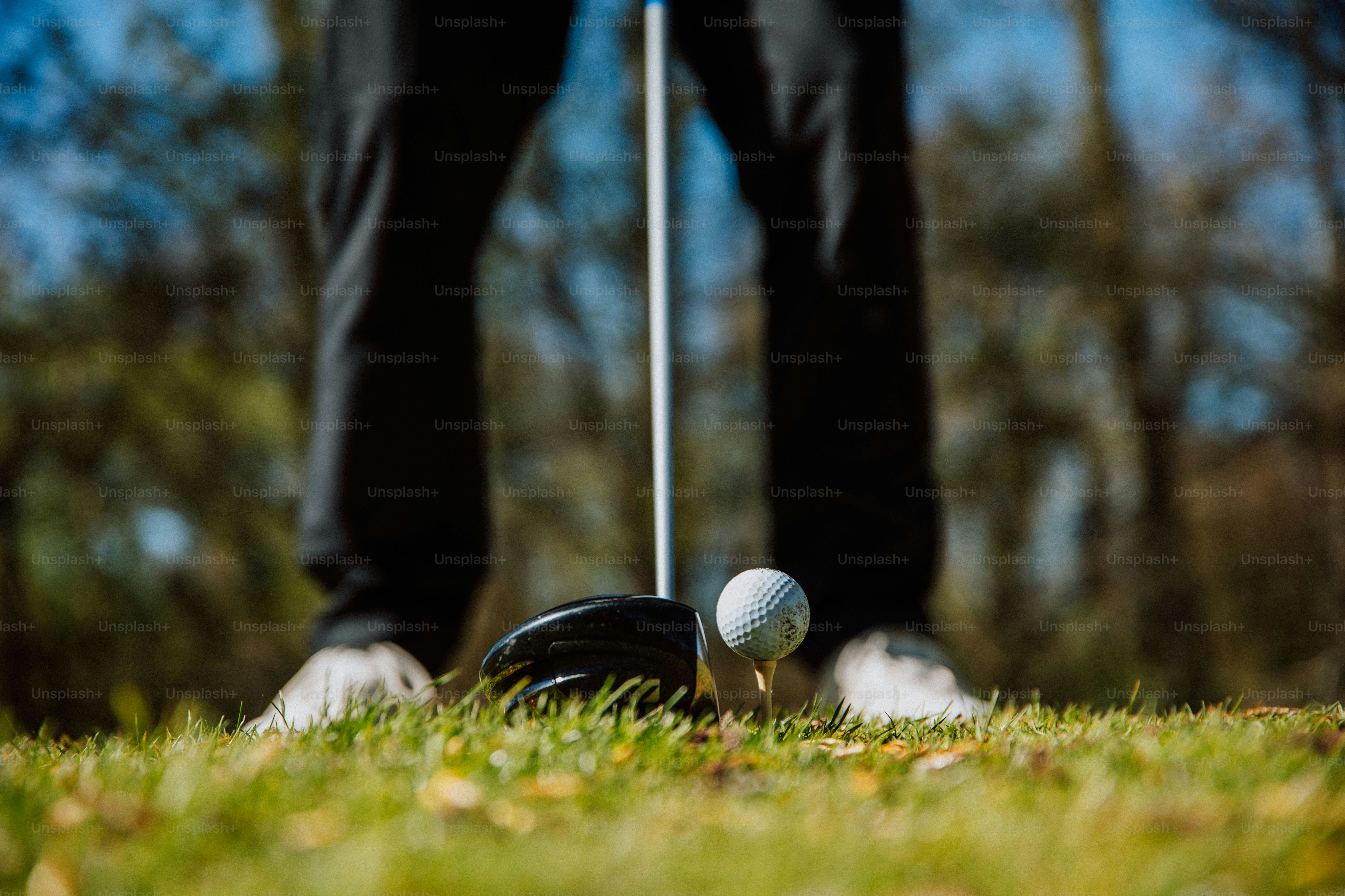 a golf ball sitting on top of a green field