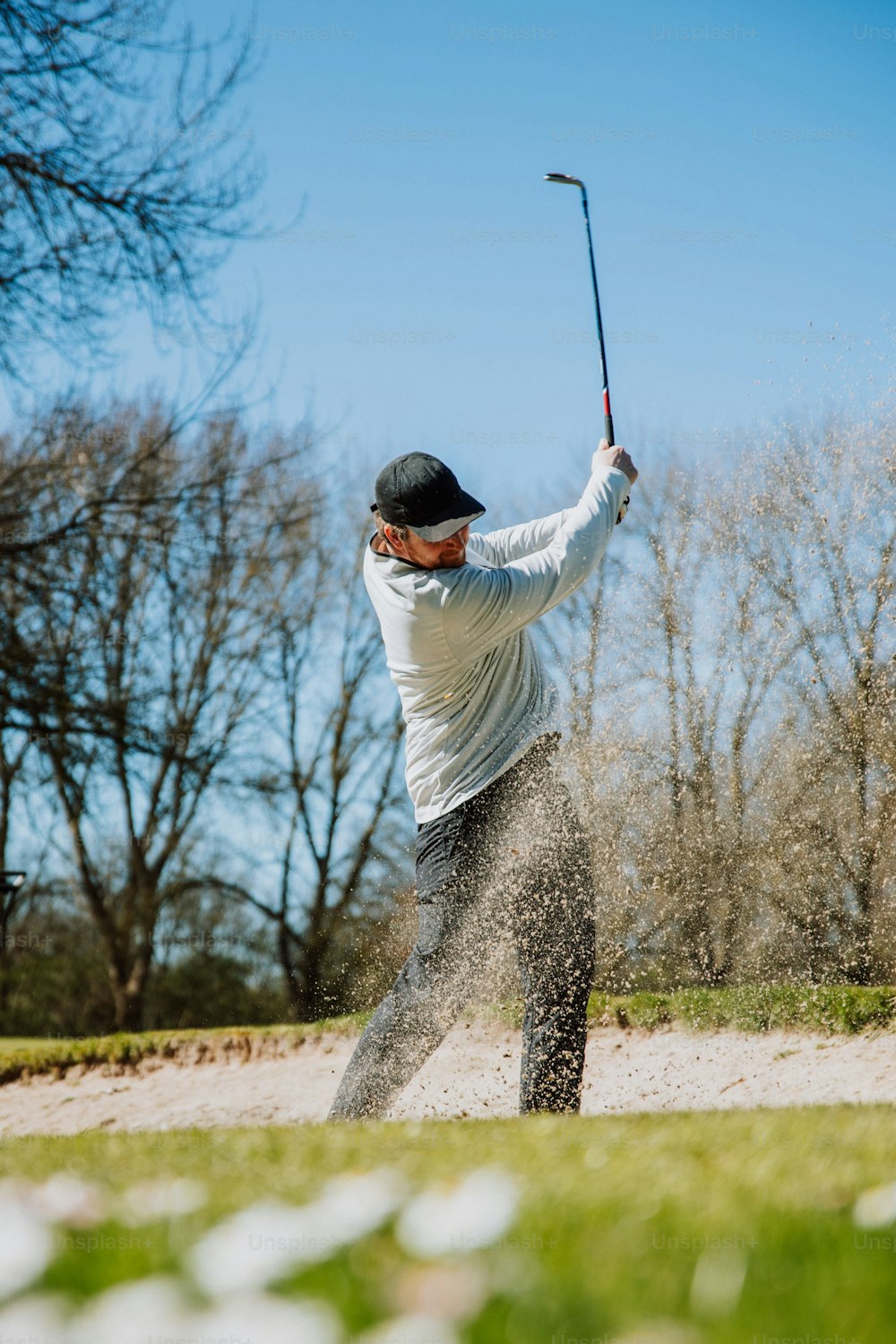 a man hitting a golf ball with a golf club