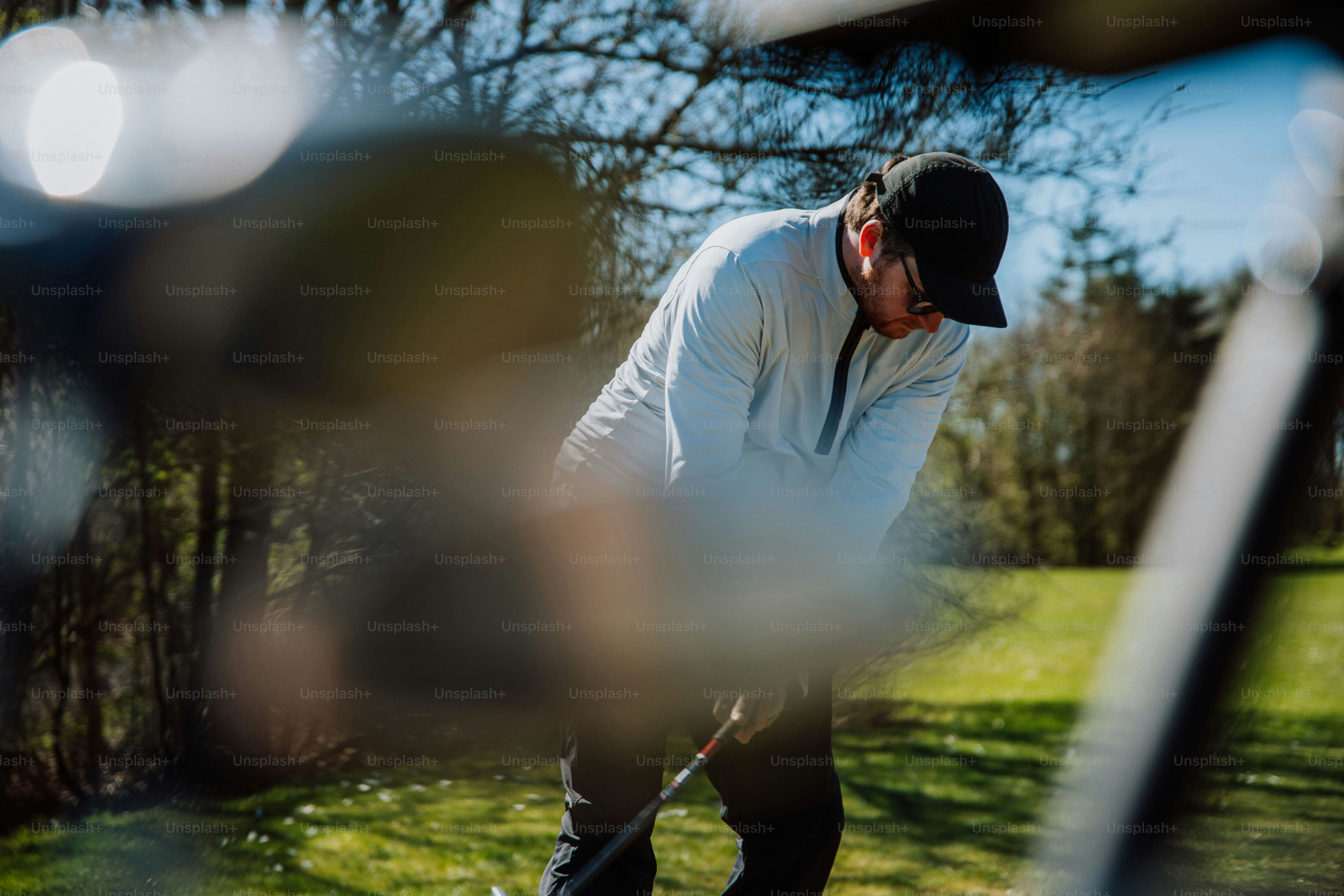 a man is playing golf in the grass
