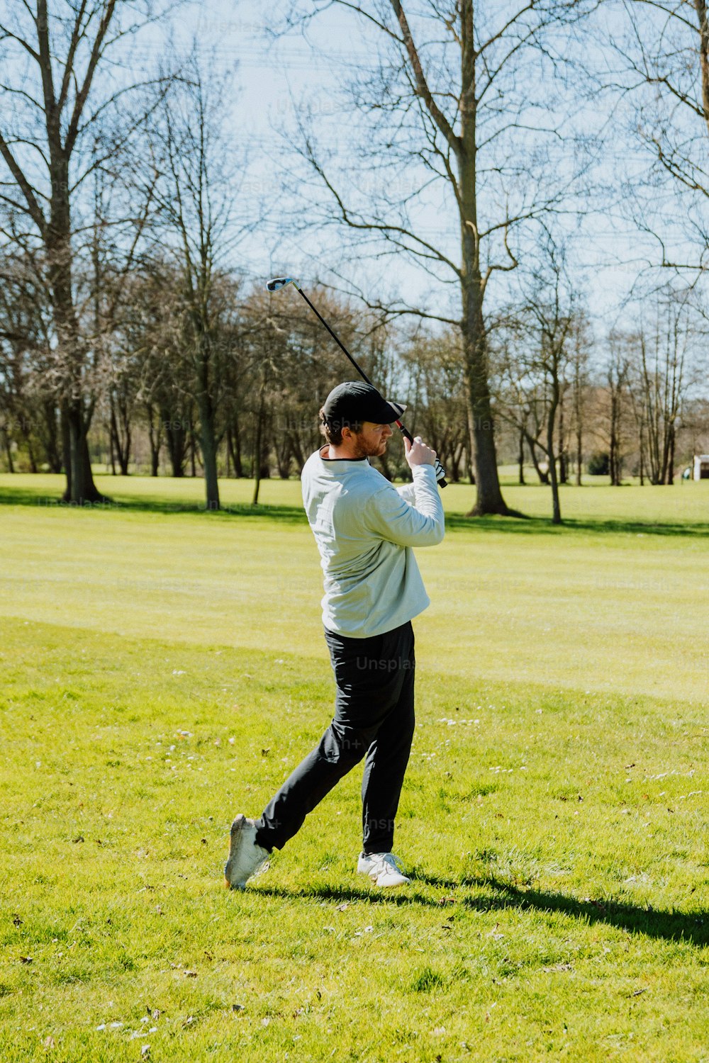 a man swinging a baseball bat on a field