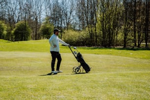 a man holding a golf club and a golf cart