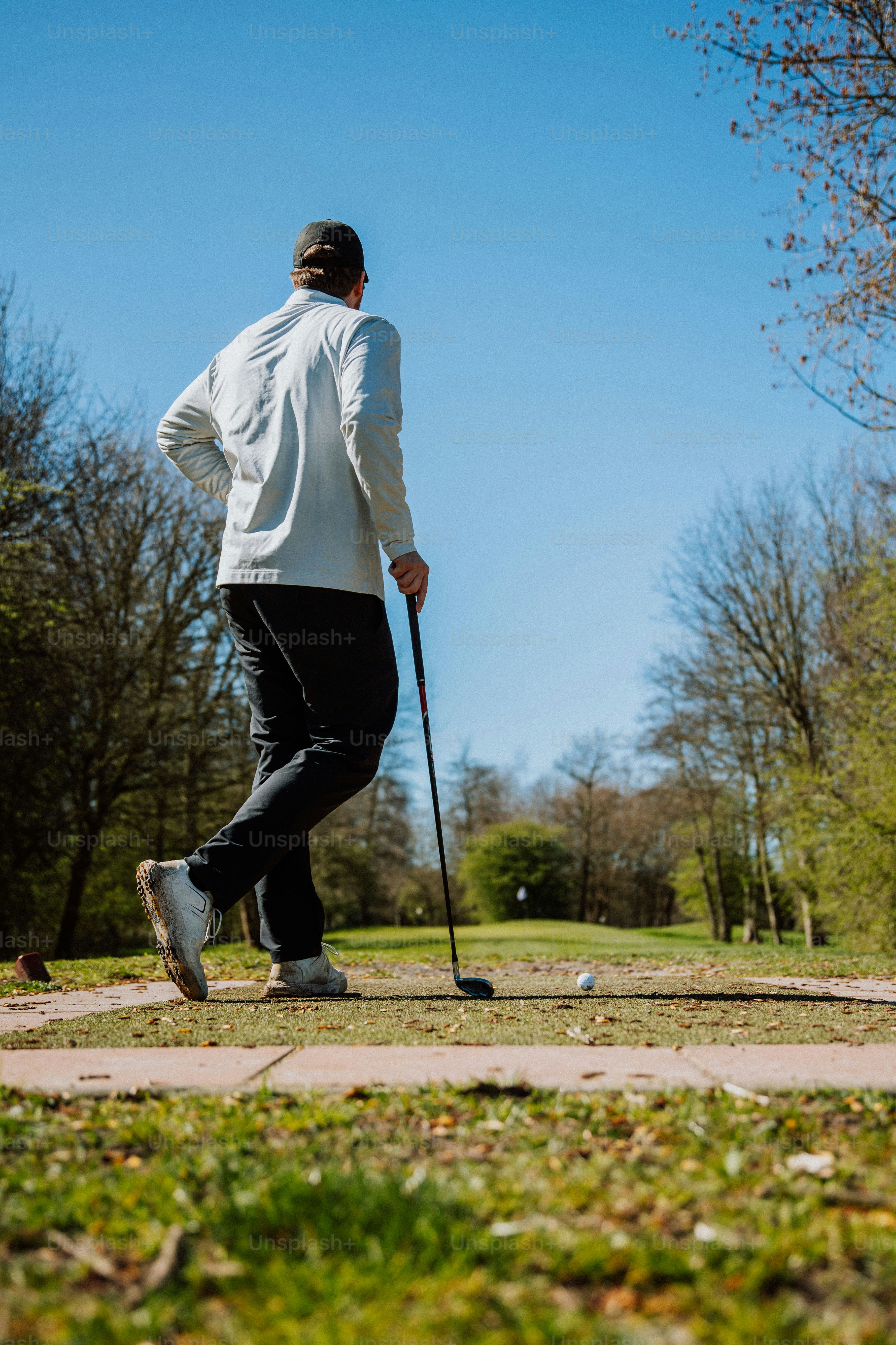 a man walking with a cane in a park