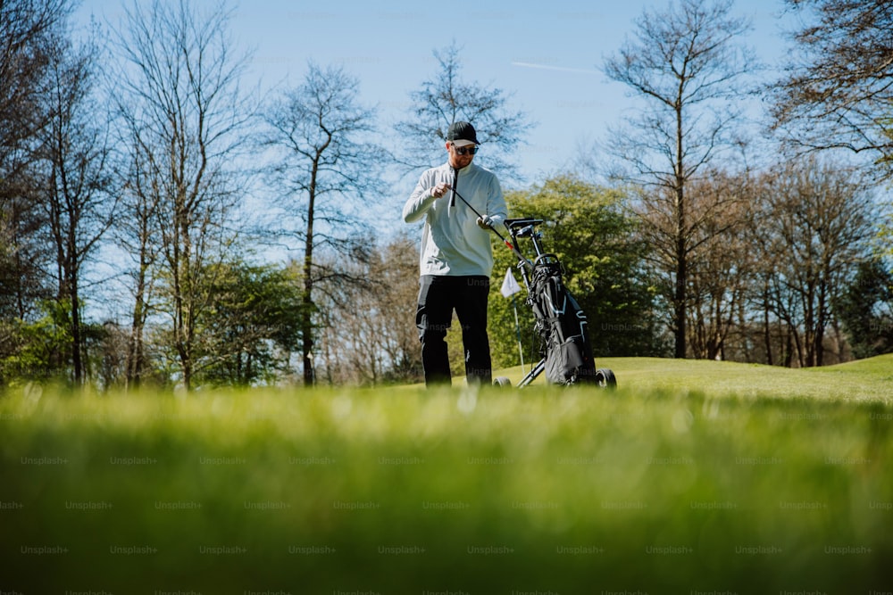 a man holding a golf club on a golf course