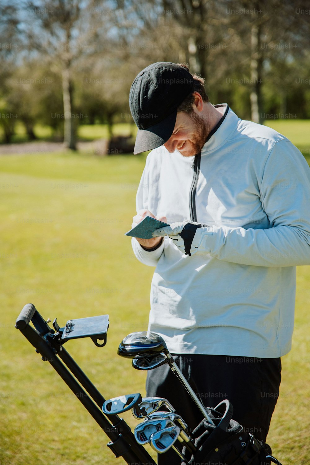 a man holding a golf club and a golf bag