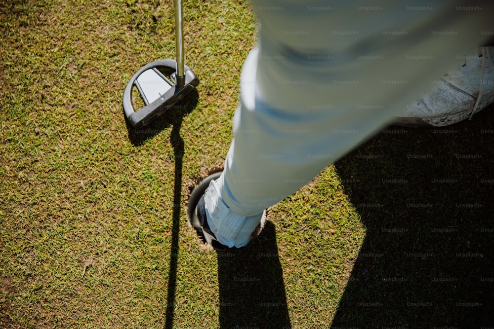 a person standing next to a pair of shoes