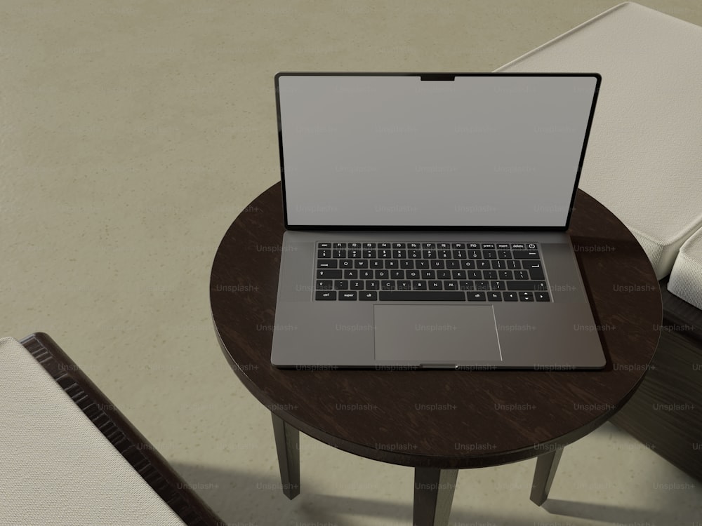 a laptop computer sitting on top of a wooden table