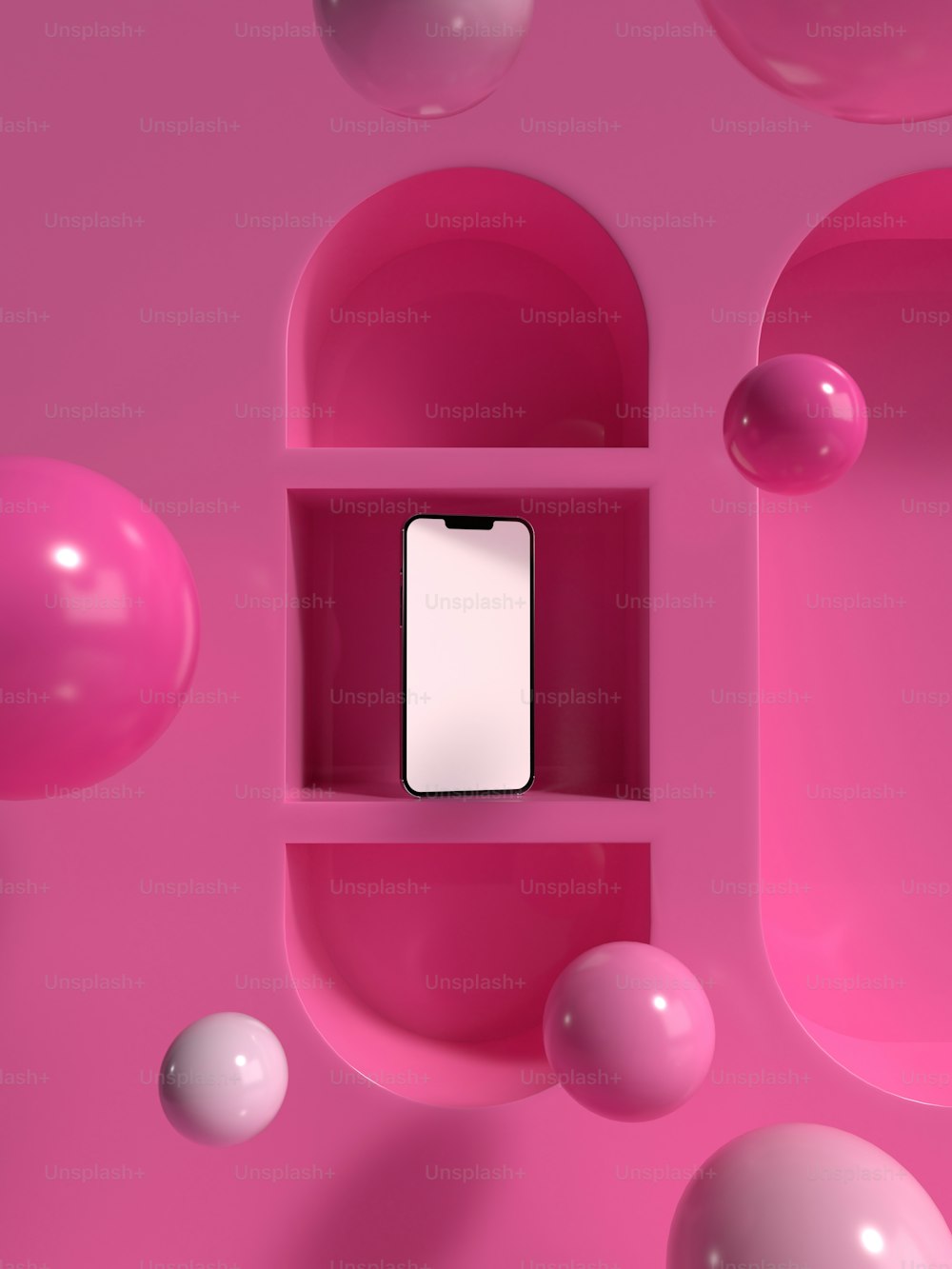 a cell phone in a pink shelf surrounded by balls