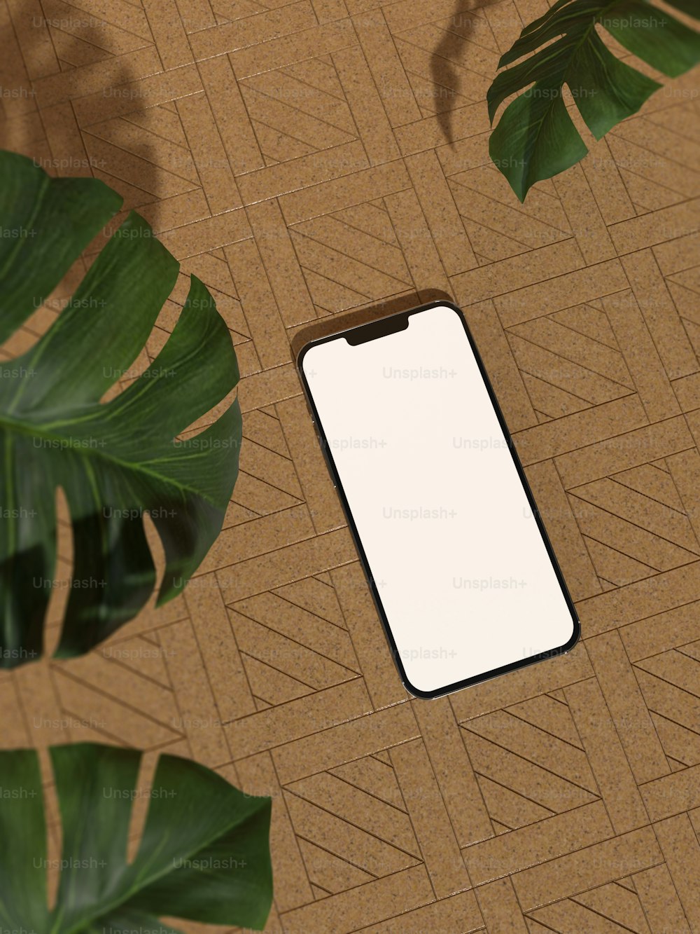 a cell phone sitting on top of a table next to a plant