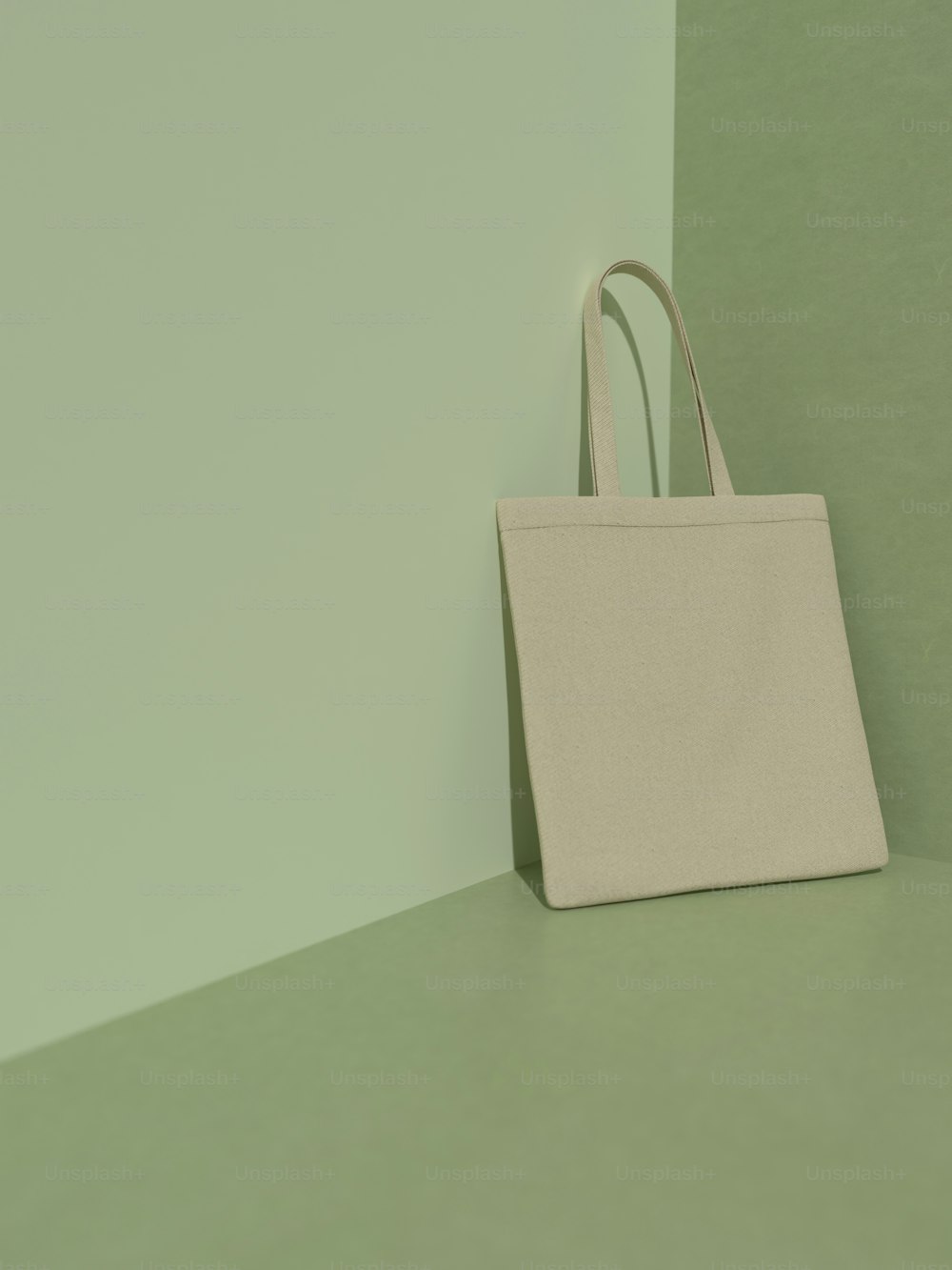 a white bag sitting on top of a green table