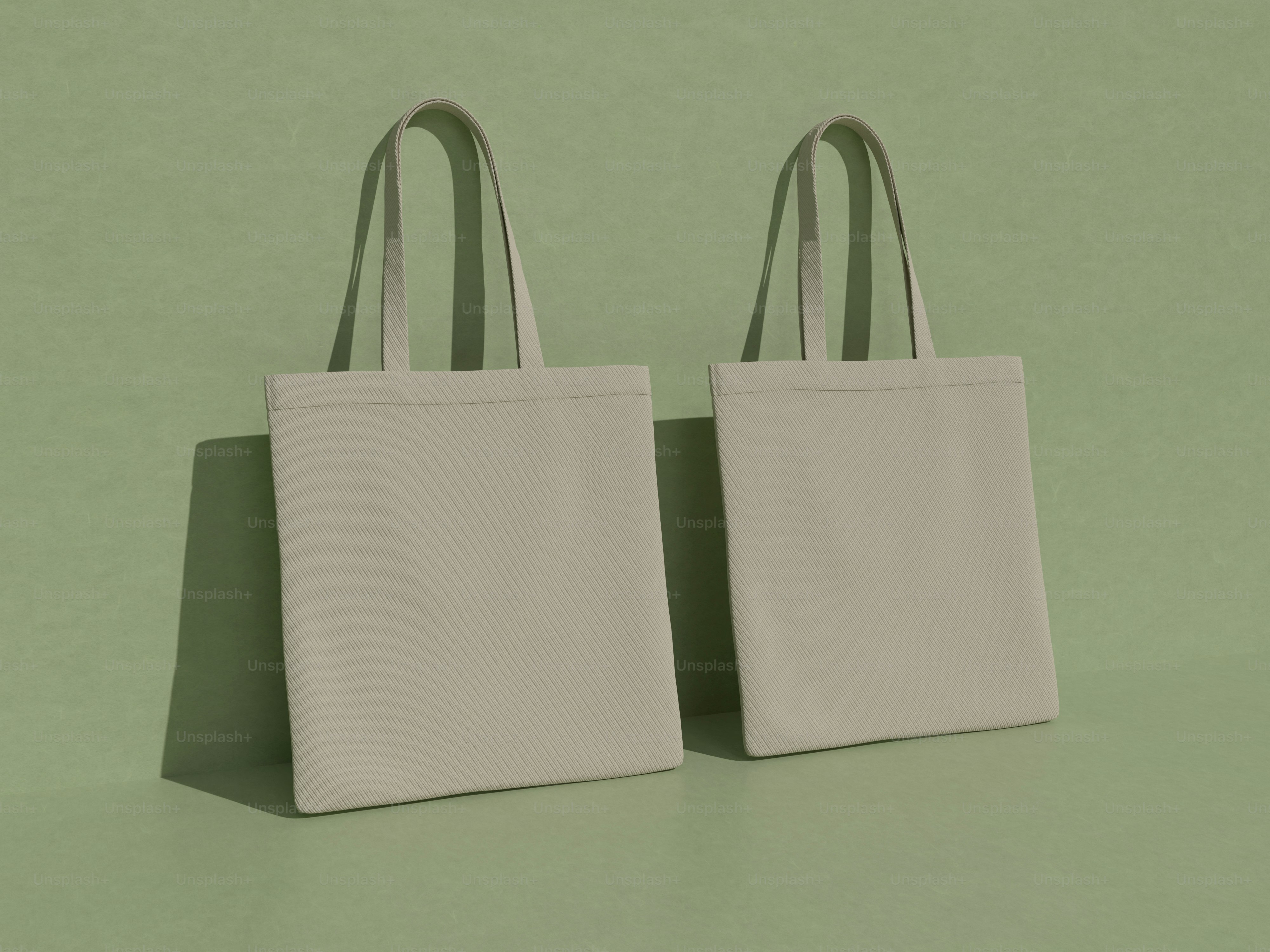 two white bags sitting on top of a green surface