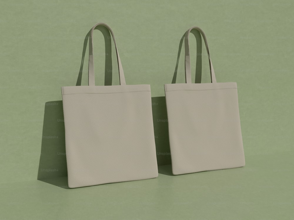 two white bags sitting on top of a green surface