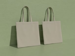 two white bags sitting on top of a green surface