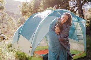 a woman and a child in a tent