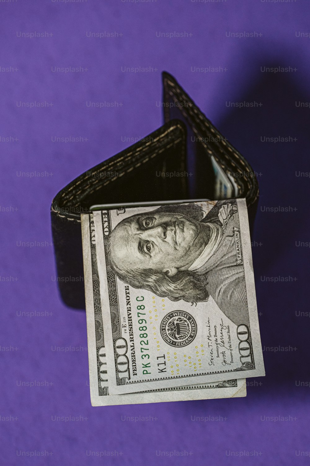 a dollar bill sticking out of a wallet