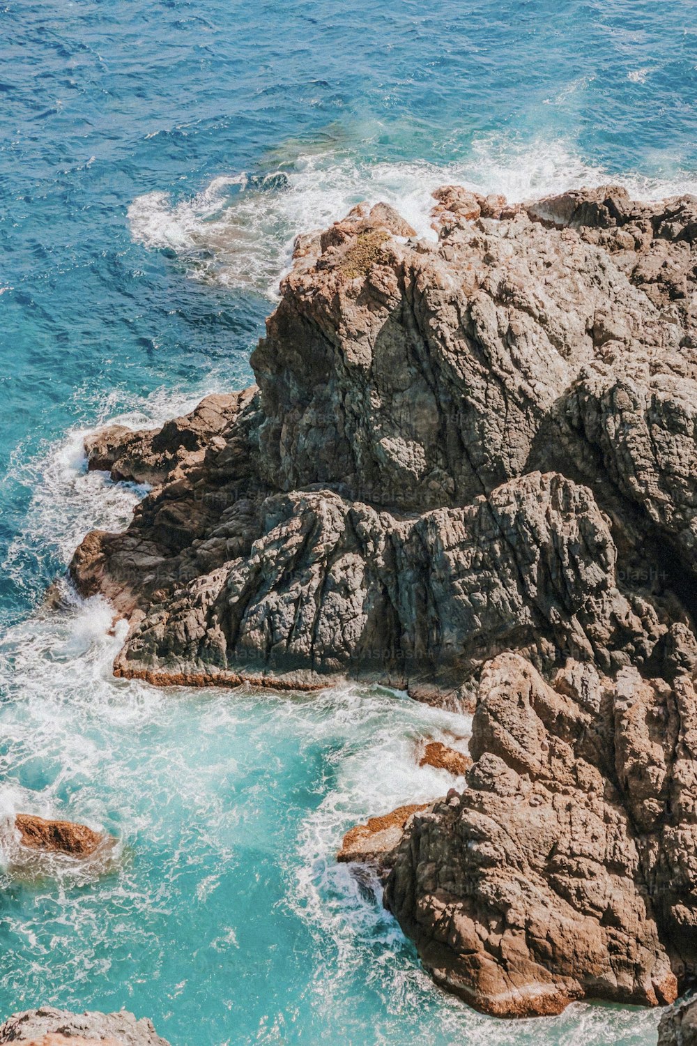 a rock formation in the middle of a body of water