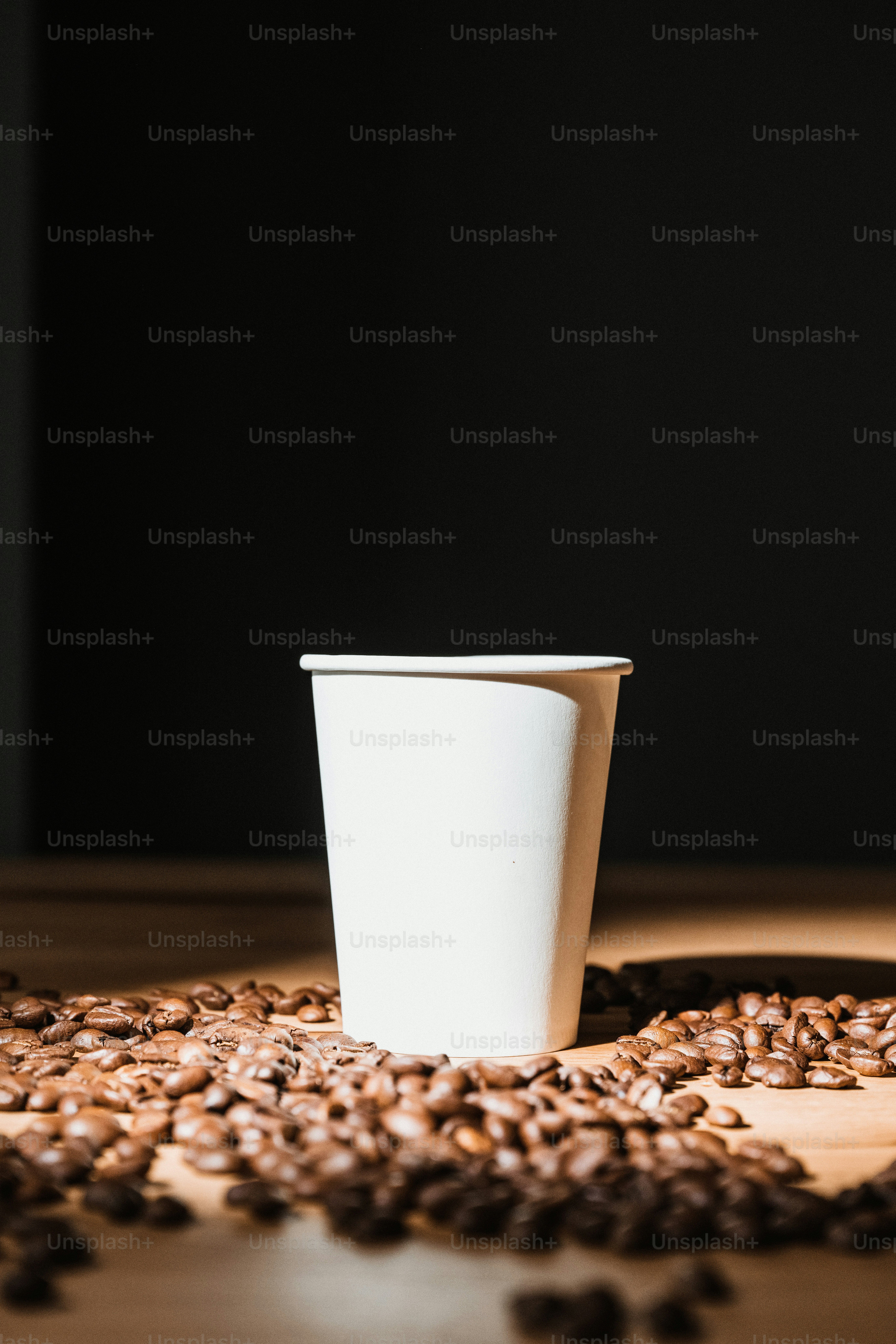 a cup of coffee sitting on top of a wooden table