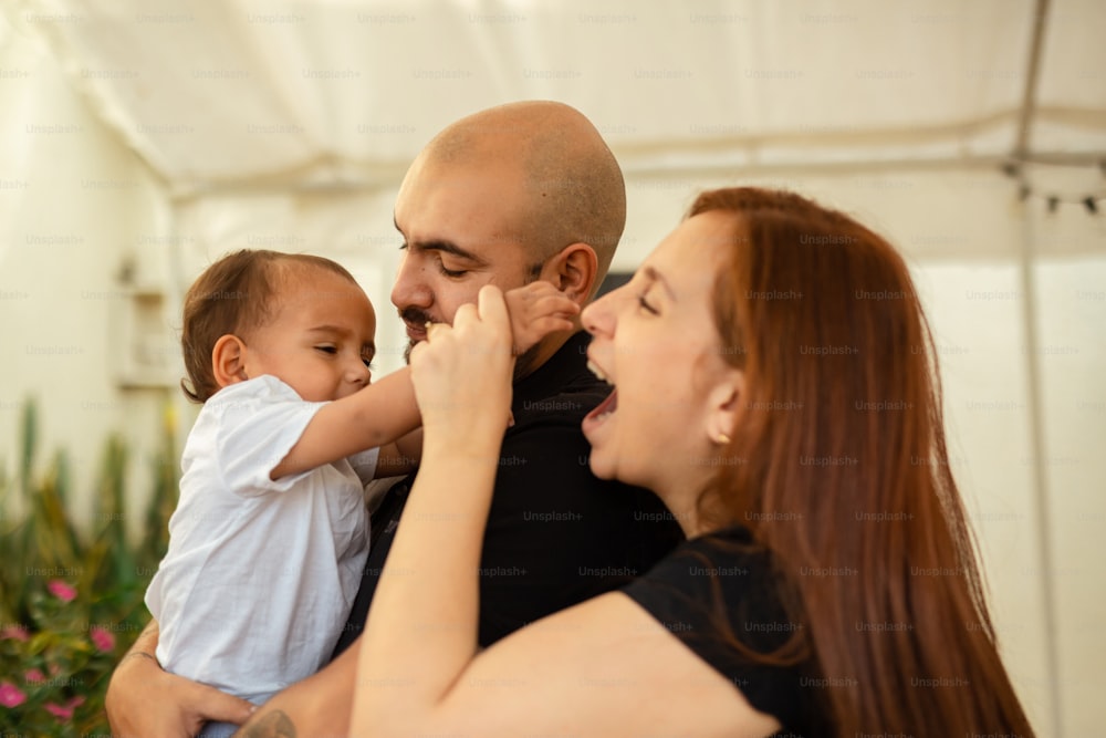 a man holding a baby and a woman holding a baby