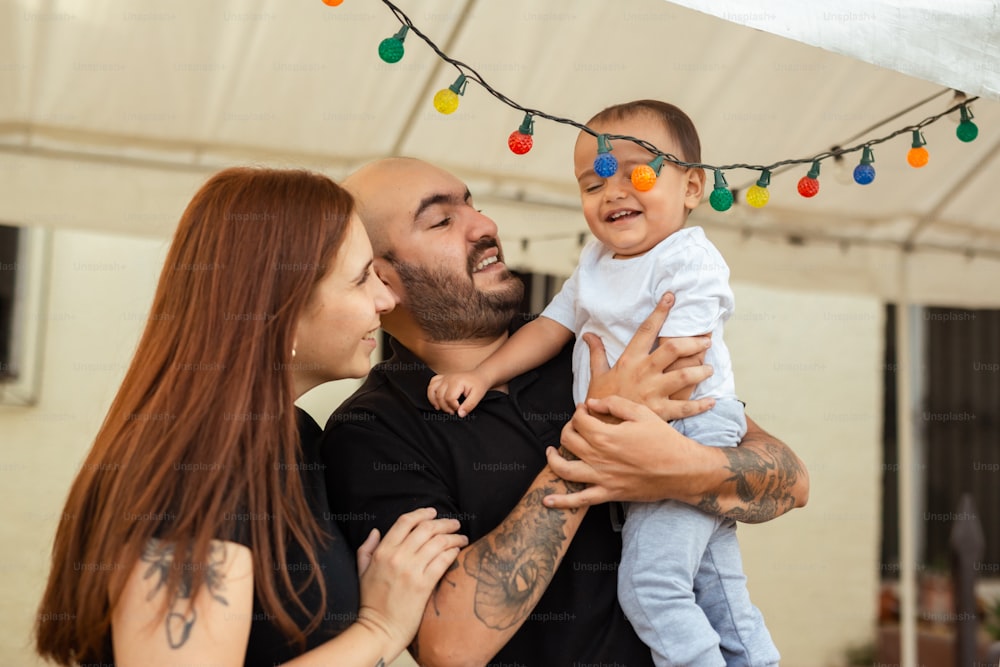 a man and a woman holding a baby in their arms