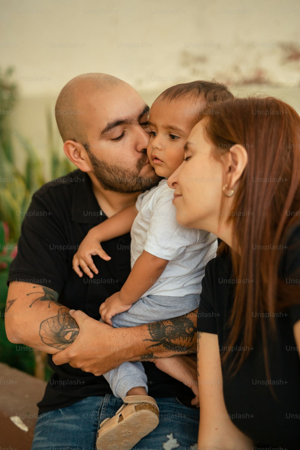 a man and a woman holding a small child