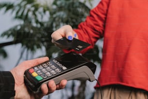 a person holding a remote control in their hand