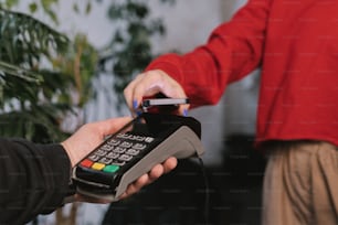 a person holding a credit card and a phone