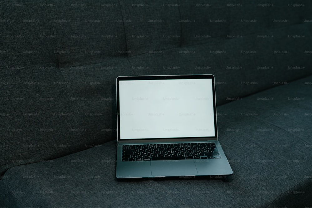 a laptop computer sitting on top of a couch