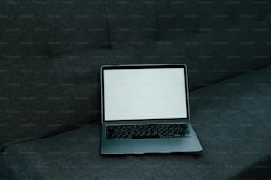 a laptop computer sitting on top of a couch