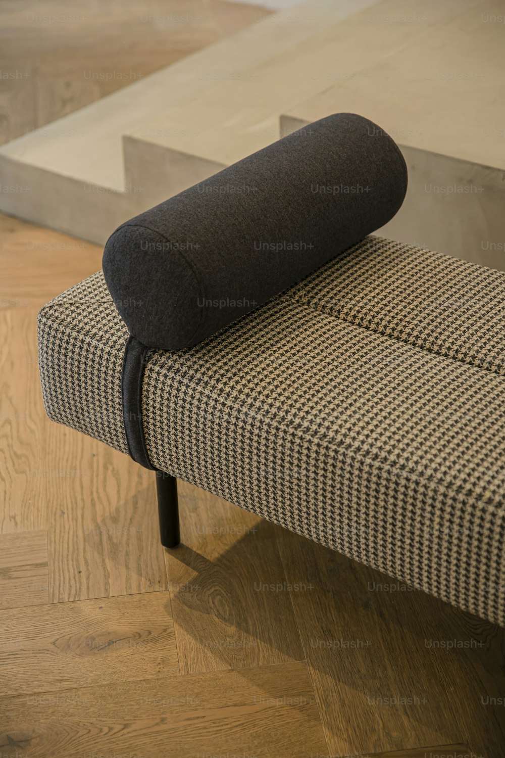 a black and white checkered bench with a black cushion