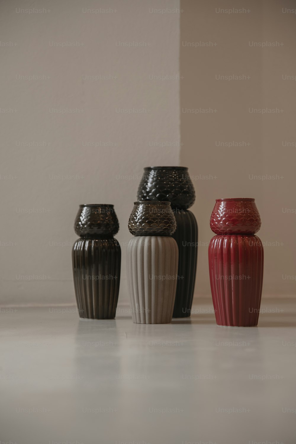 a group of three vases sitting next to each other