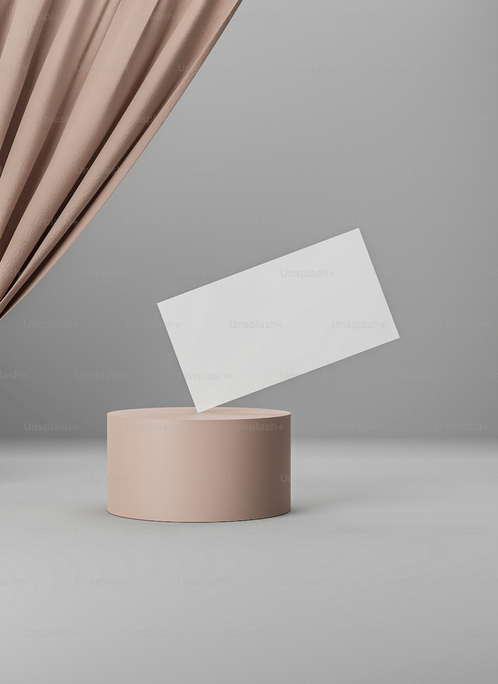a white business card on a stand next to a curtain