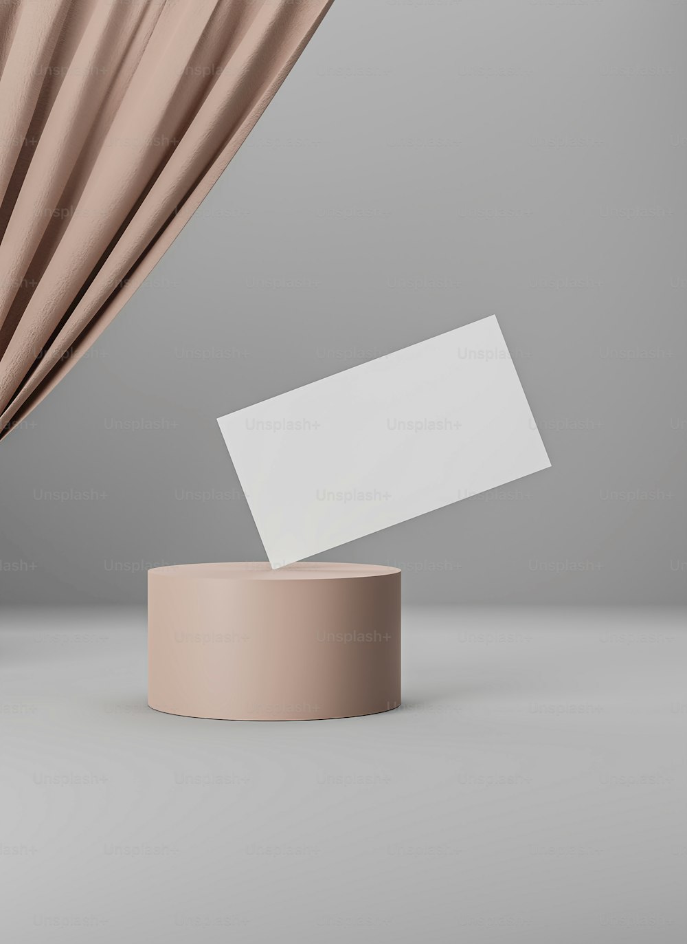 a white business card on a stand next to a curtain