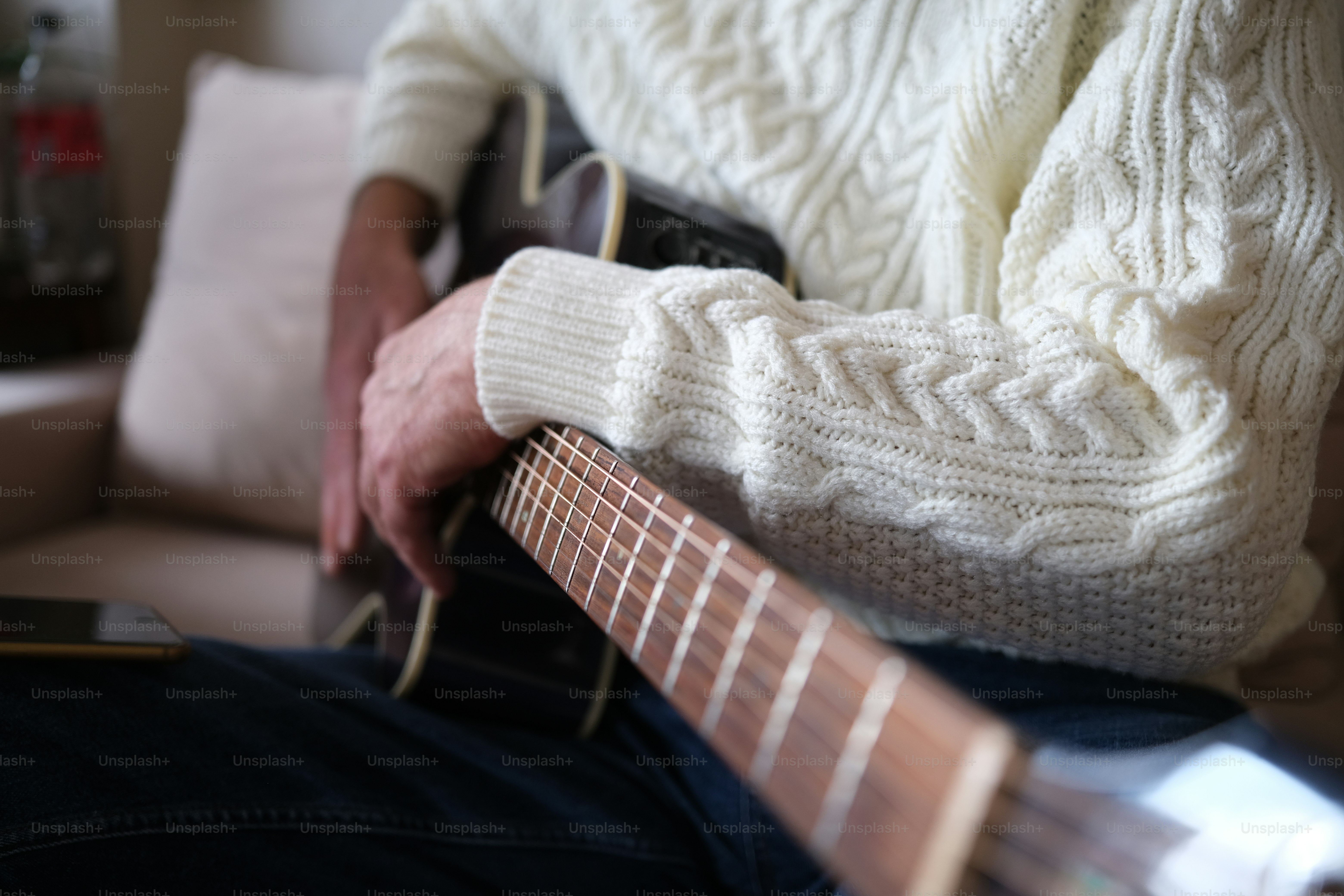 a close up of a person playing a guitar