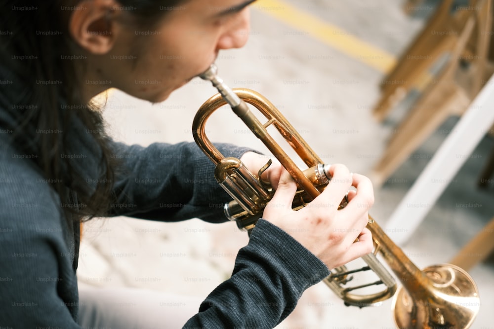 a woman is playing a trumpet outside