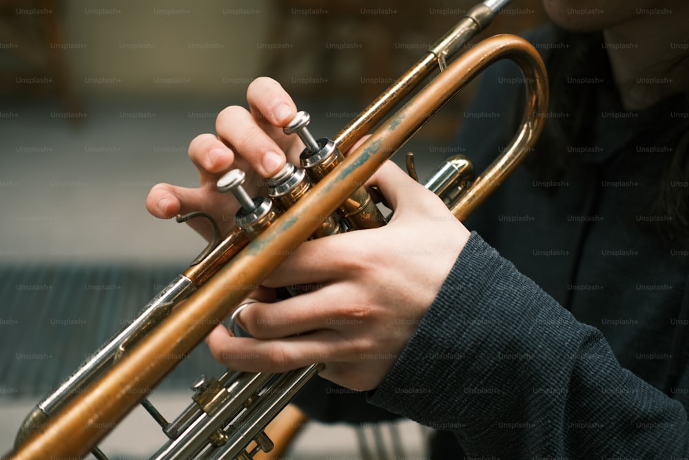 a close up of a person playing a trumpet