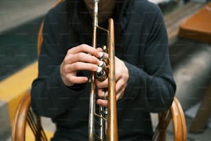 a person holding a trumpet in their hands