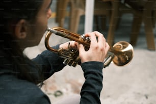 uma mulher tocando um trompete na rua