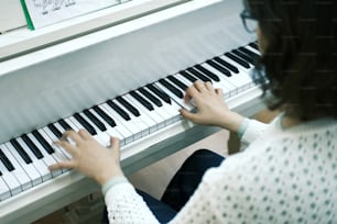 女性が手でピアノを弾いている