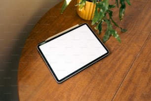 a tablet computer sitting on top of a wooden table