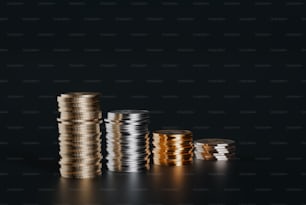 a stack of gold and silver coins on a black background